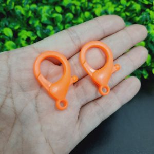 Broches perico de plástico naranja